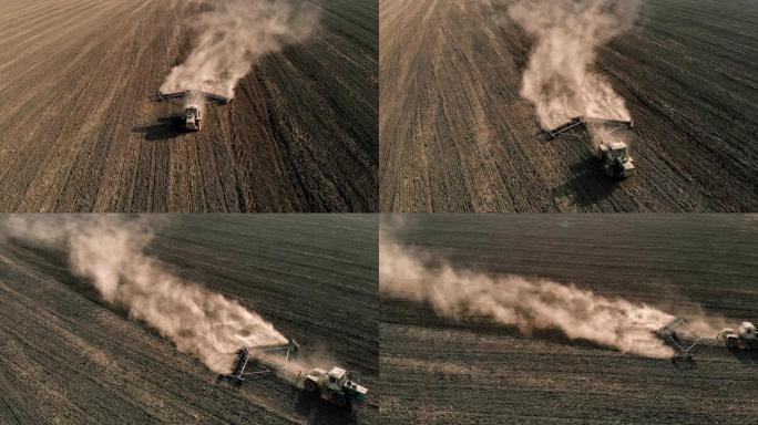 带有中耕机的农用拖拉机在田间骑行，使干燥的土地松散，并产生大量灰尘