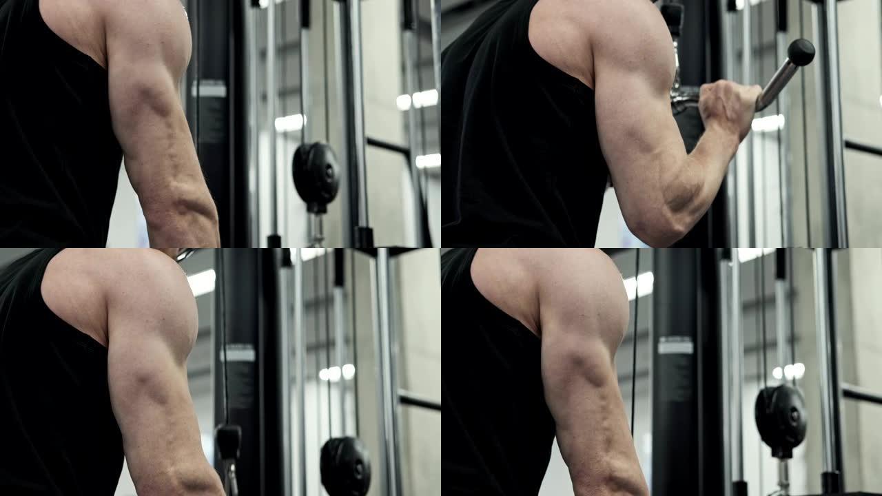 男性训练手臂肱三头肌肌肉使用电缆机进行体重。