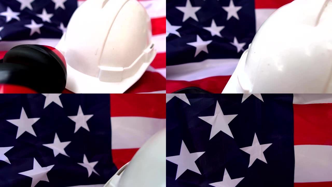 劳动节创意:把帽子和各种劳动防护用品放在美国国旗上