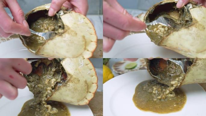 从4k的蟹壳中挖出美味的棕色肉的特写镜头。