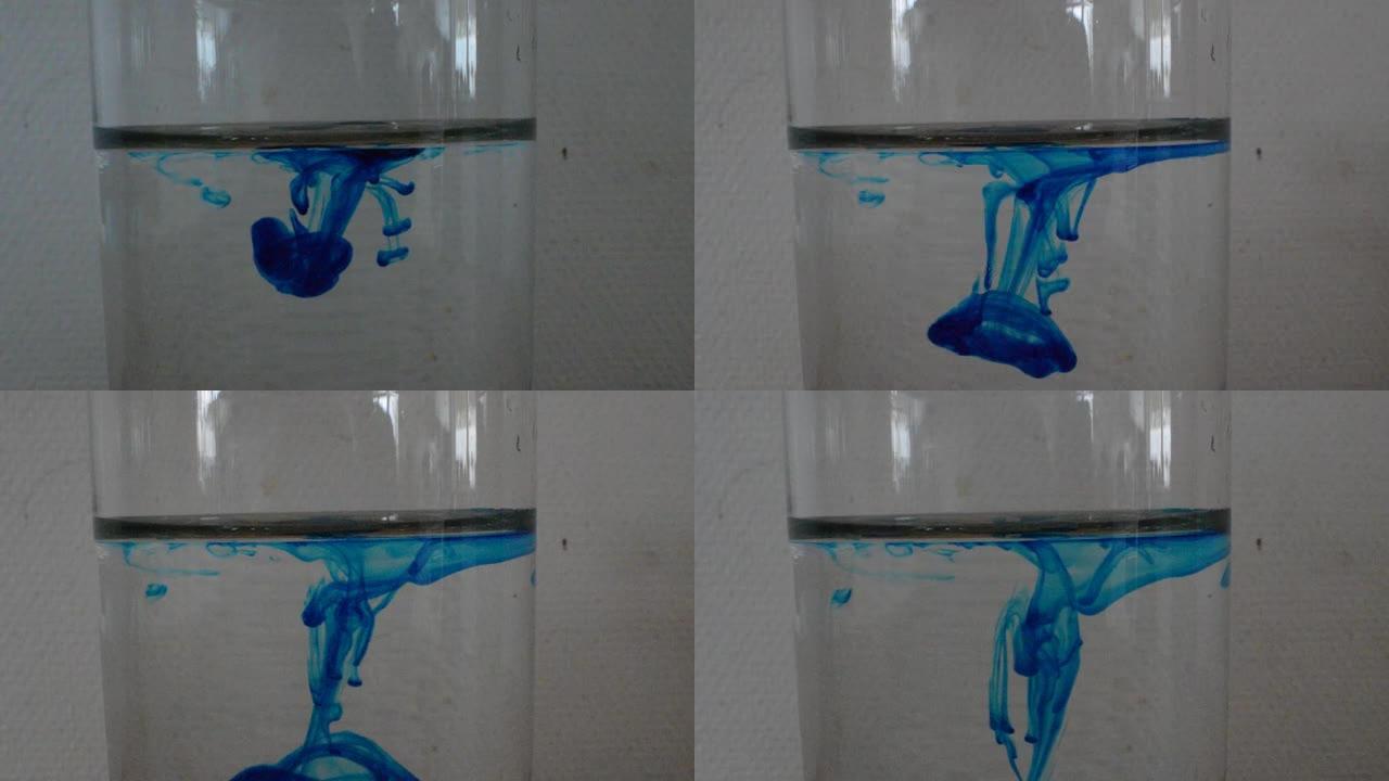 将一滴蓝色染料放入水中的流体动力学实验