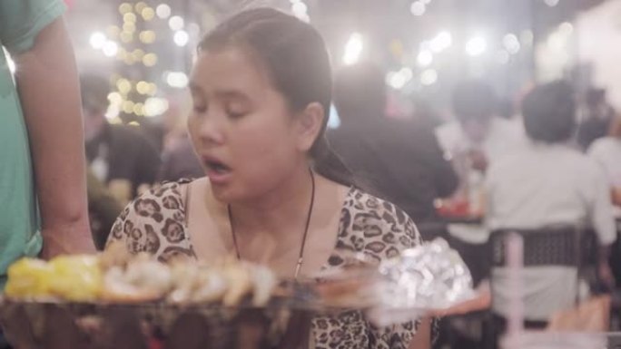 描绘30-40岁的亚洲女性在新年节上与海烧烤派对，泰国受欢迎的街头美食海鲜。
