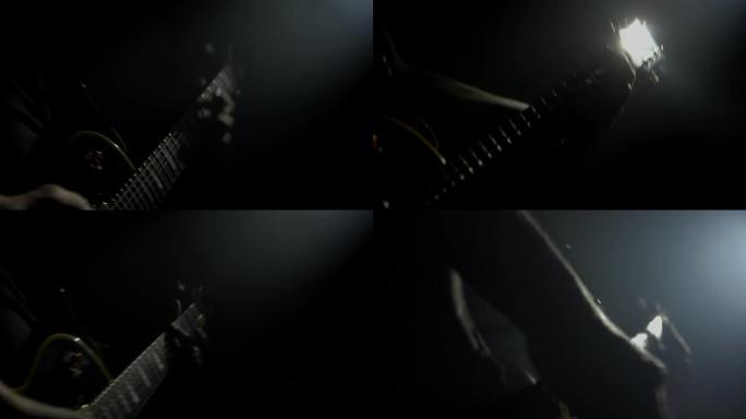 男吉他手在音乐会上演奏电贝斯。乐器背景，特写