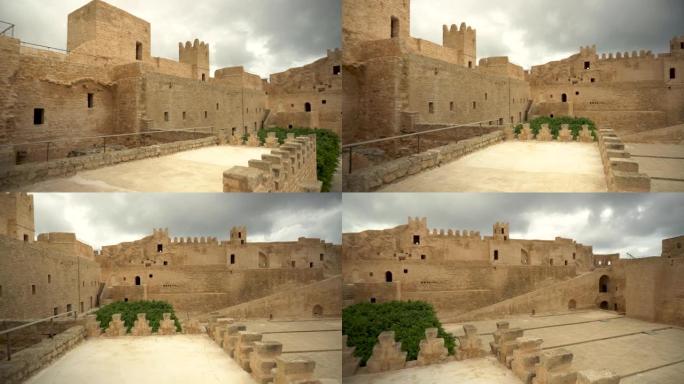 全景漫步穿过突尼斯莫纳斯提尔的古老里巴特要塞。旧的黄砖。从左到右查看