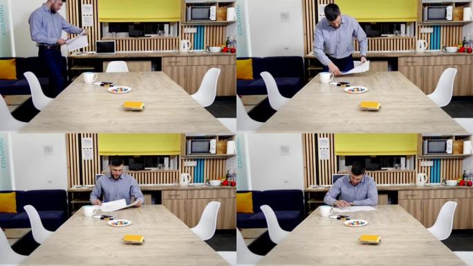 早上办公室工作。同事在餐桌旁工作，喝茶，