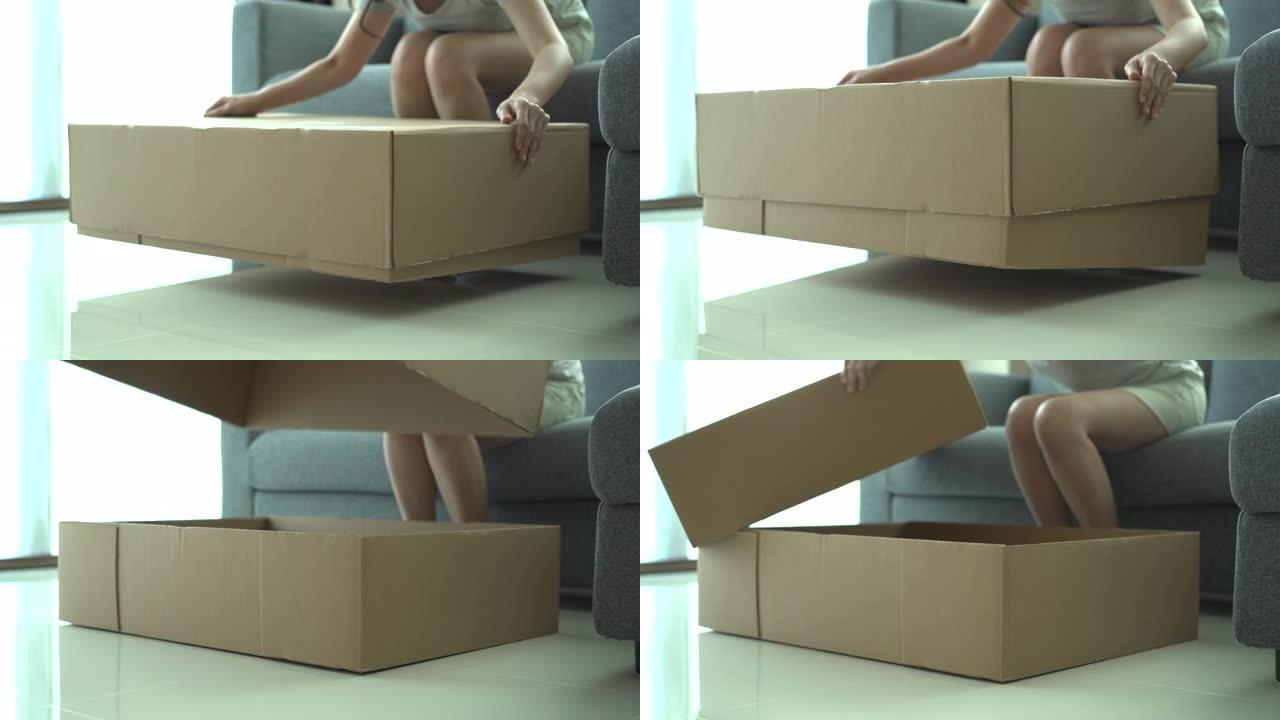女人打开或打开纸板包装箱。