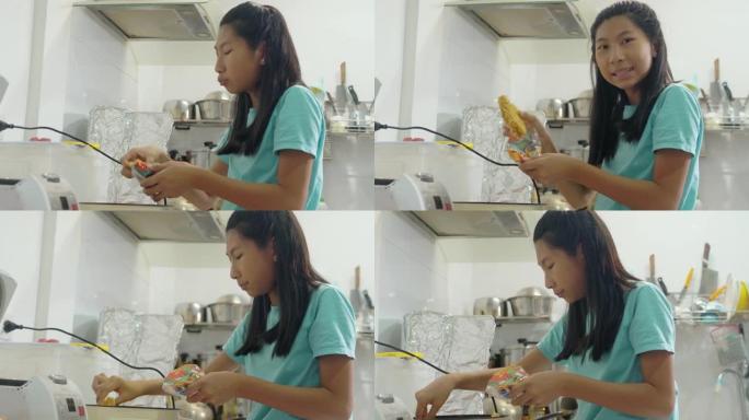 快乐的亚洲女孩在家厨房做饭，呆在家里的生活方式理念。
