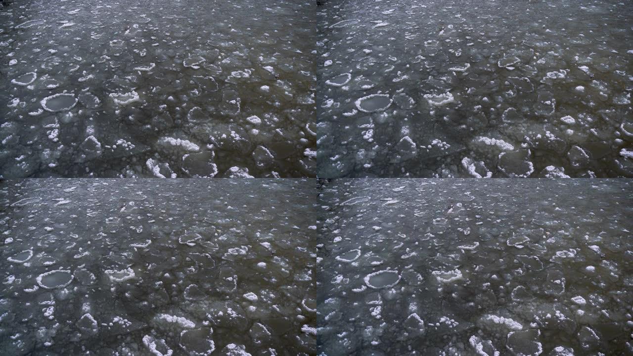 裂开的浮冰的鸟瞰图。全球变暖，气候变化冬季背景