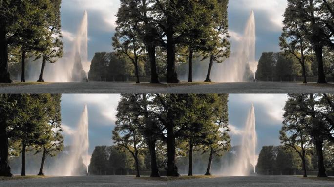 德国汉诺威。巨大的高喷水器从放在地上的碗中倒出。在公园绿树的背景下。性关系、精子、射精、高潮的概念。