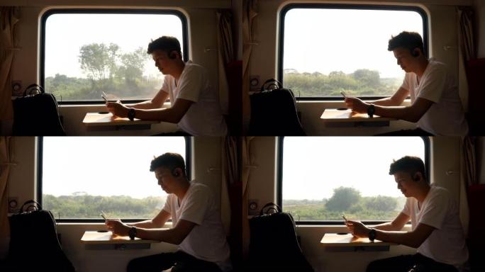 亚洲男子在火车上使用移动智能手机