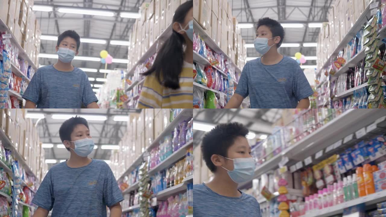 亚洲男孩和他的妹妹在新型冠状病毒肺炎前戴着口罩，为家人囤积食物，生活方式概念。