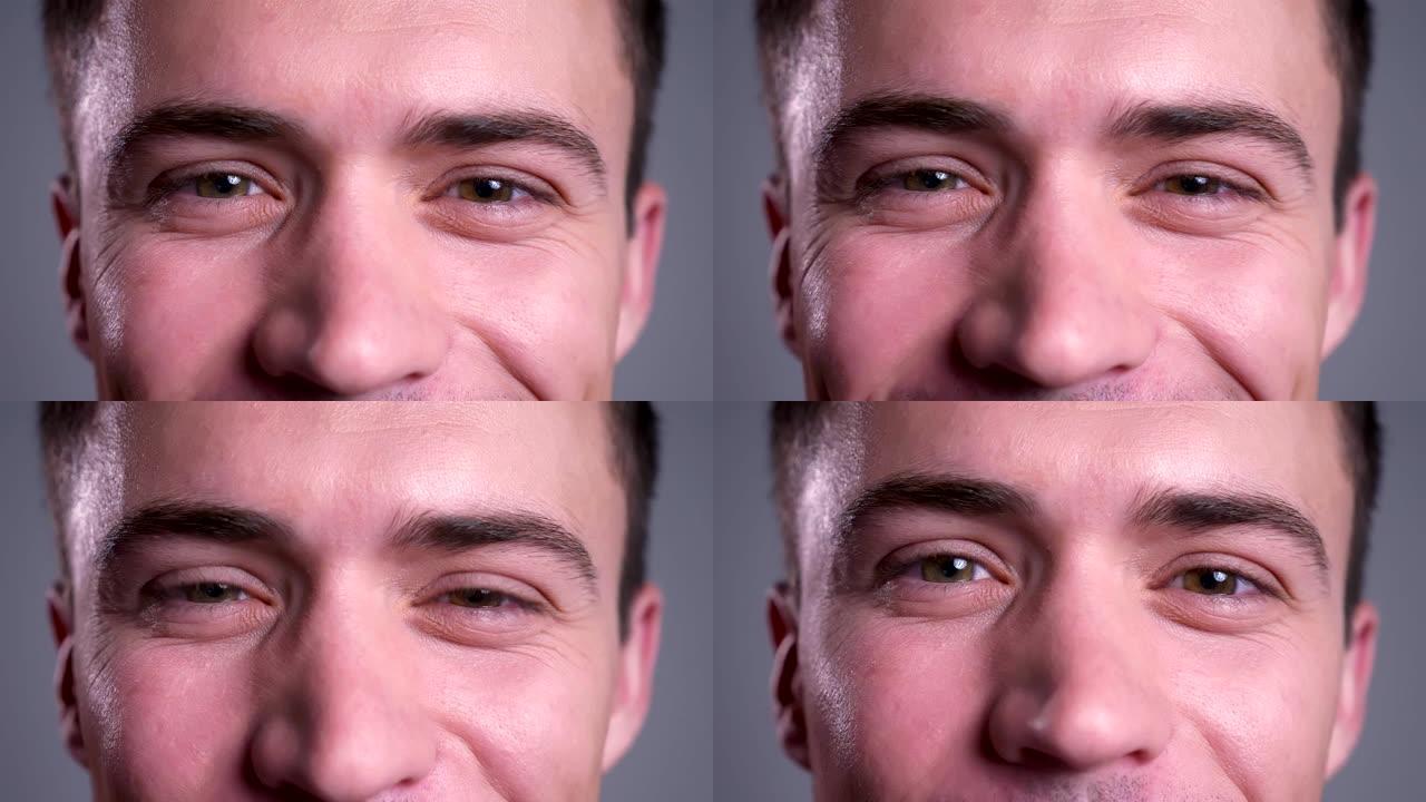 迷人的高加索男性棕色眼睛直视相机的特写肖像，面带微笑的面部表情