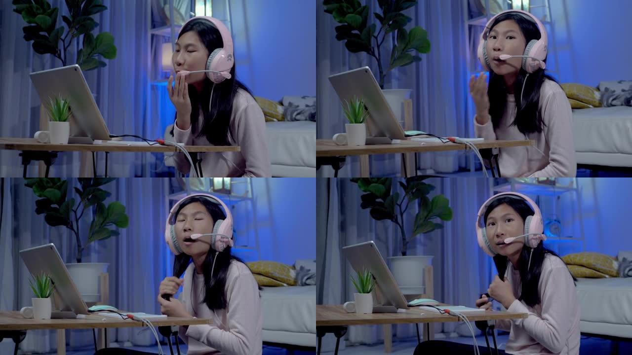 亚洲女孩戴着带麦克风和数字平板电脑的耳机，在新型冠状病毒肺炎期间与老师和朋友在家上学，社交距离和新的
