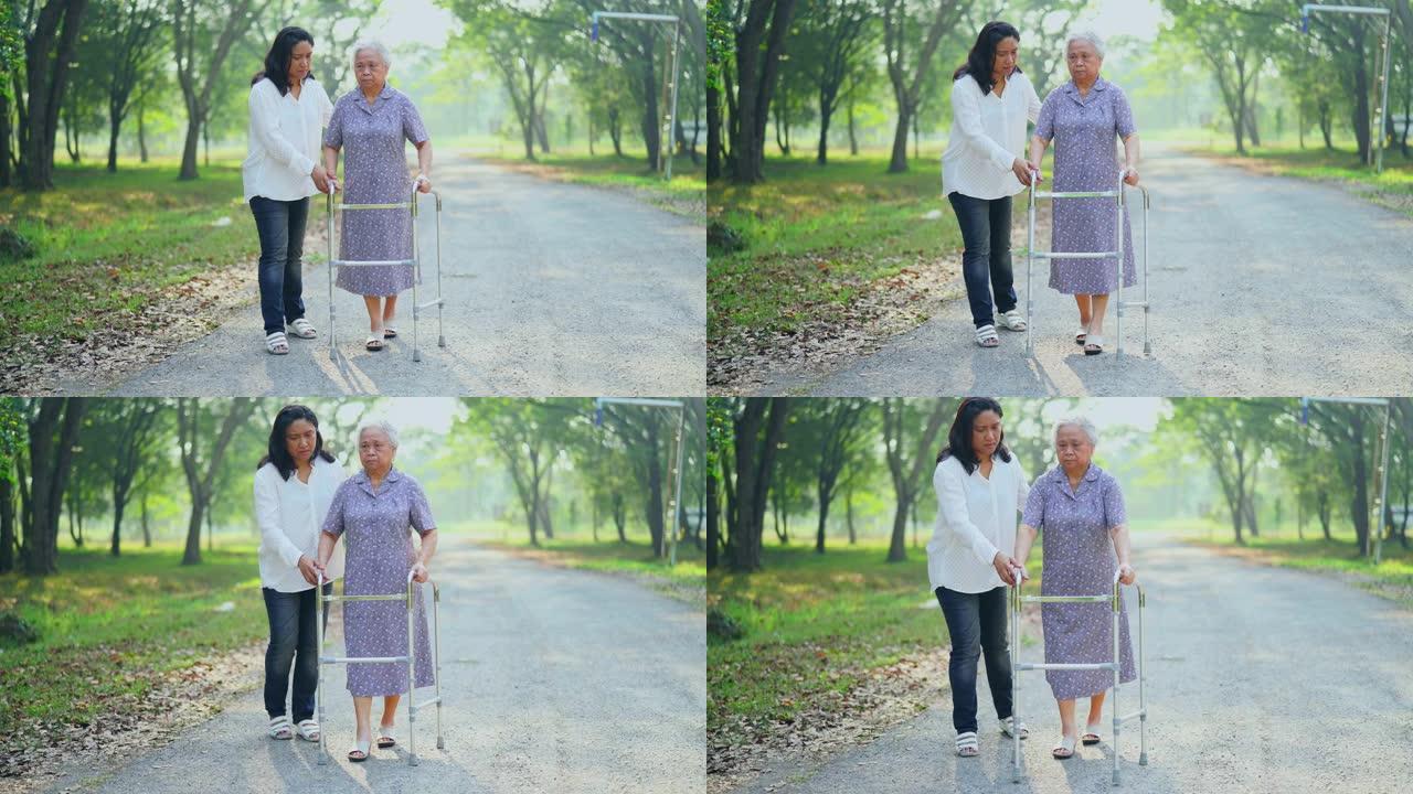 亚洲女士护理，帮助和支持老年或老年老太太患者在医院病房与步行者同行: 健康的强大医疗理念。
