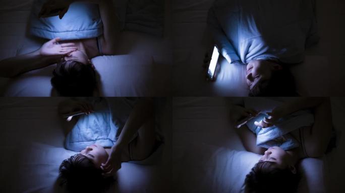 女人晚上在床上使用手机