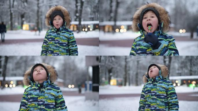 五岁的小男孩在公园的街上吃棒棒糖