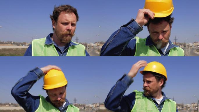 一个留着胡子和小胡子的工人抽烟，戴上黄色头盔。4k视频
