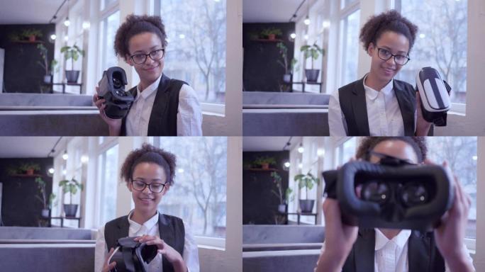 未来就是现在，快乐的非洲裔美国少女戴上眼镜，戴上相机上的虚拟现实头盔