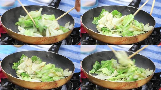 女人做饭做白菜炒鱼露。
