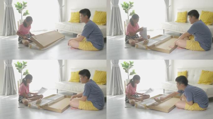 亚洲孩子试图将他们的新白色架子组装在一起，这是从网上购物，生活方式概念中购买的。