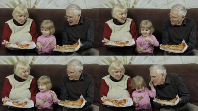 美丽的老年男女和孙女一起吃披萨