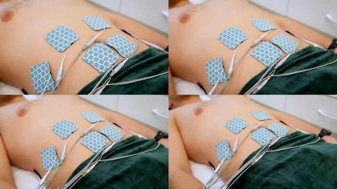 水疗中心男性腹部的替代静电按摩。人体抗衰老治疗程序