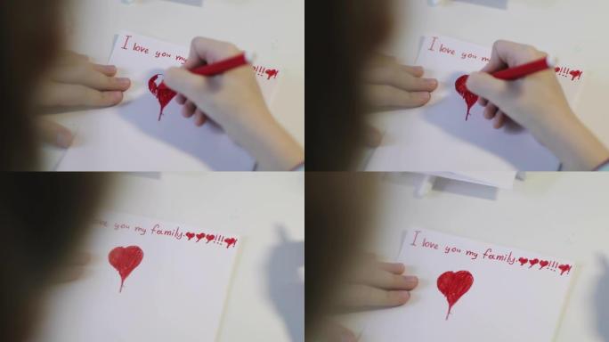 可爱的孩子在一张白纸上画一颗红色的心。