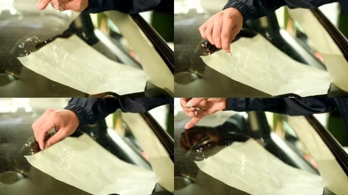 Man专业消除汽车挡风玻璃上的裂纹净化多余的聚合物