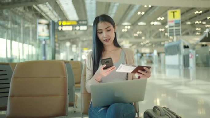 亚洲商务女性在机场检查航班。
