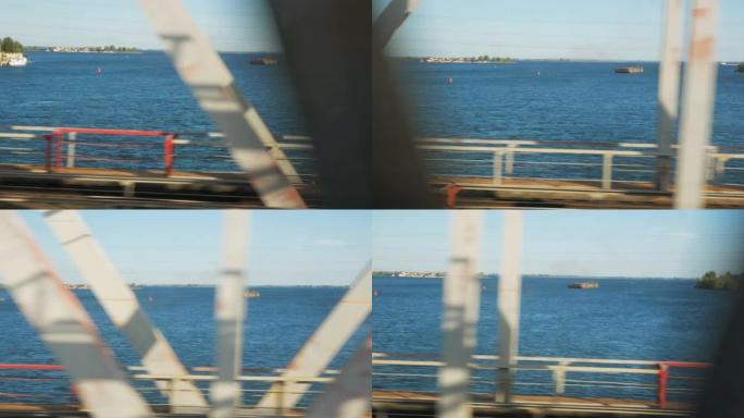 在一条宽阔的河上经过一座巨型桥。伏尔加河。从火车窗口观看