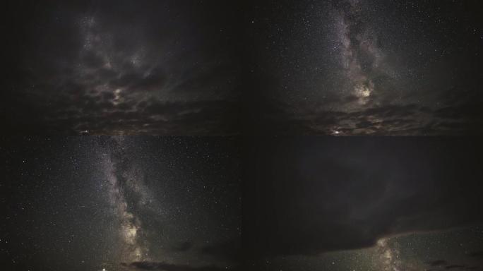 银河系在云层之间穿越夜空的延时