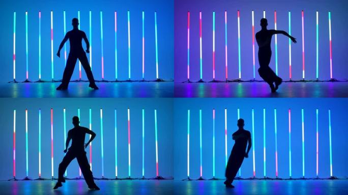 舞厅舞者在黑暗的工作室独奏表演。在明亮的彩色霓虹灯的背景下，舞者的深色轮廓。慢动作