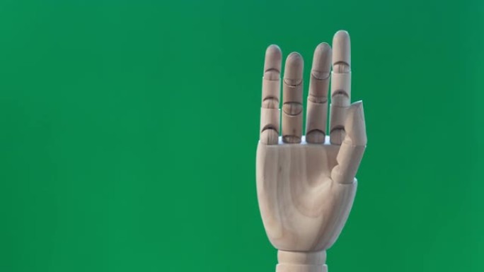 绿色背景上的4k定格动作手减速爱情符号，情人节概念。
