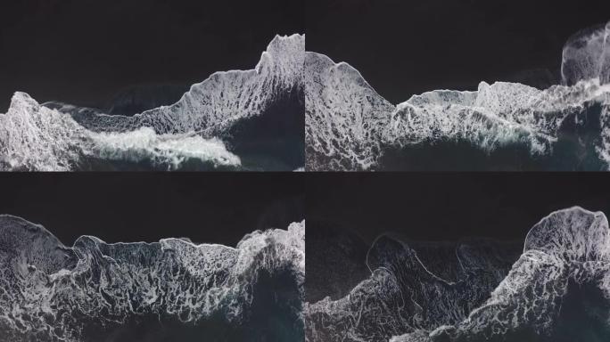 鸟瞰图。黑色火山沙滩。波浪一个接一个地滚动。