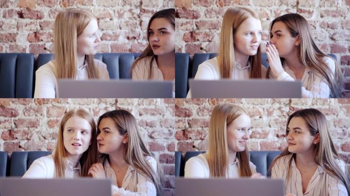 追踪两个漂亮的年轻女人在咖啡馆里看着某人闲聊的正确镜头。女人在朋友的耳边窃窃私语，在他们面前打开笔记