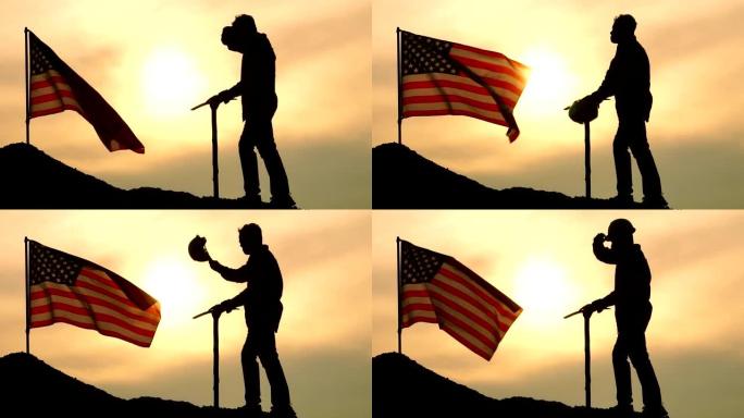 劳动节概念:举着鹤嘴锄的劳工站在美国国旗上