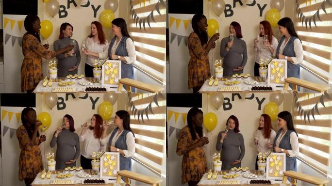 孕妇在家与女性朋友庆祝婴儿送礼会。
