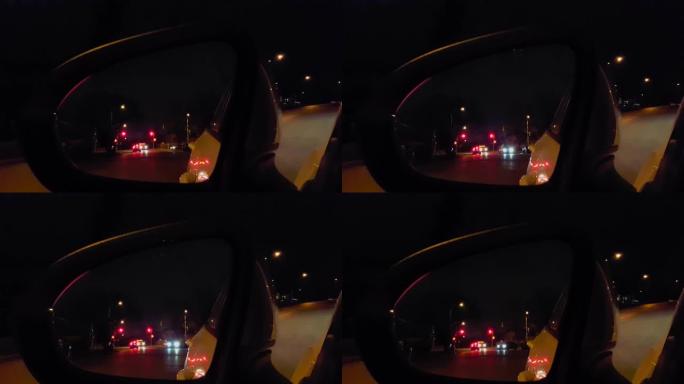 夜间汽车侧镜视图。晚上街道交通的车辆后视。