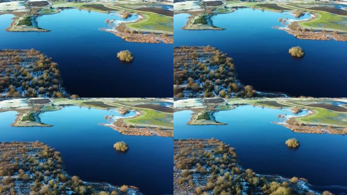 在一个平静的冬天早晨，在缓慢移动的苏格兰河中宽阔的小岛的鸟瞰图