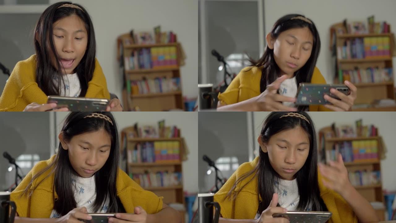 穿着黄色毛衣的亚洲女孩在家坐在椅子上观看病毒视频，生活方式概念。