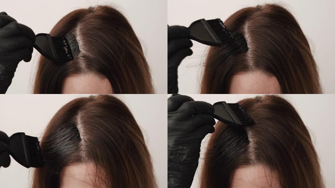 女人用刷子染成灰色发根。家中的染发技巧