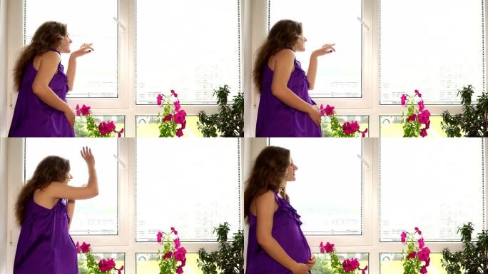 美丽的孕妇透过百叶窗看