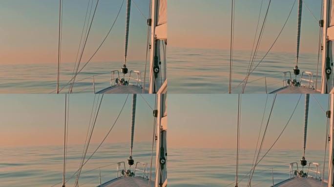 日落时，帆船在大西洋平静的宁静海水中鞠躬。帆和钻机的视图