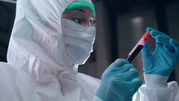 微生物学和病毒学概念，实验室科学家在防护服中手持血浆试管并阅读书面数据。新型冠状病毒肺炎感染患者的血