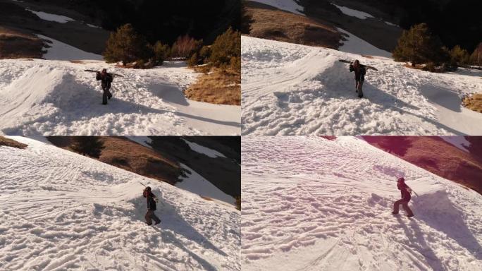 鸟瞰图女运动员滑雪者沿着斜坡徒步攀登，在高加索山区的一个家乡，滑雪板在踢球者旁边的肩膀上。