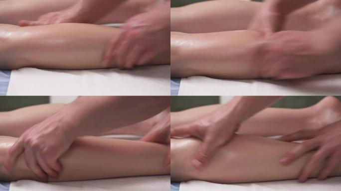 专业治疗师的特写镜头，为女性患者的小腿肌肉加温并准备按摩。运动按摩和肌肉操作