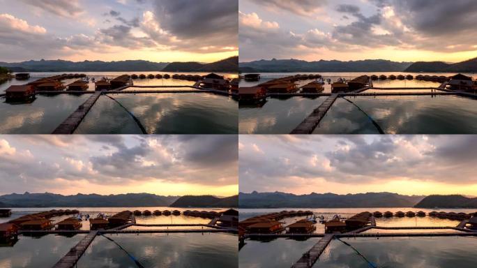 日落时分，在北碧的阿南塔河山，漂浮在斯利那卡琳大坝上的木筏度假胜地