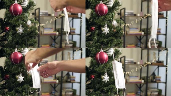 在圣诞树上悬挂白色医用面膜作为装饰品。