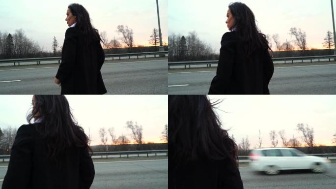 长发女孩站在马路上。