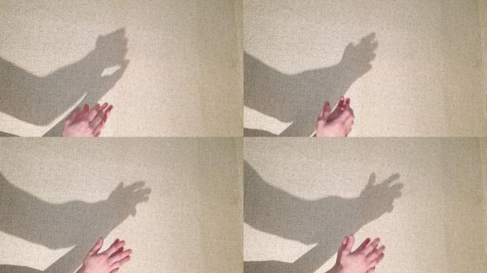 握手的阴影。颤抖的手影在墙上。